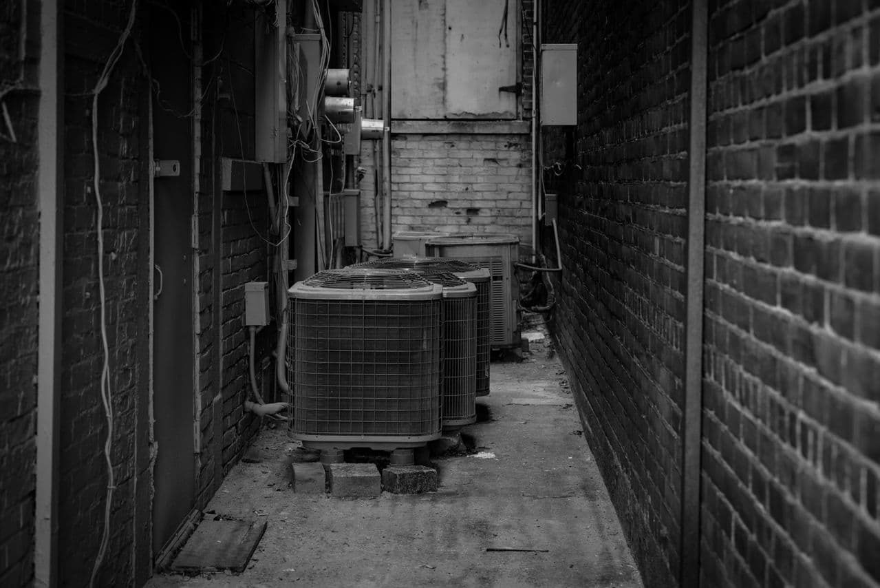AC condenser units in a service alley